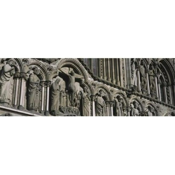 Low angle view of statues carved on wall of a cathedral Trondheim Norway Poster Print by - 36 x 12