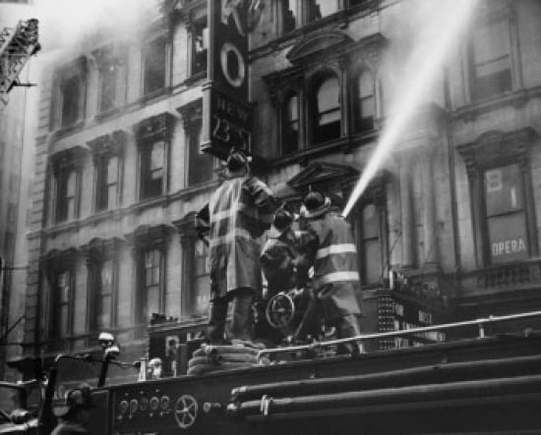 Low angle view of three firemen spraying water on a burning movie theater New York City New York State USA Canvas Art - (24 x 36)