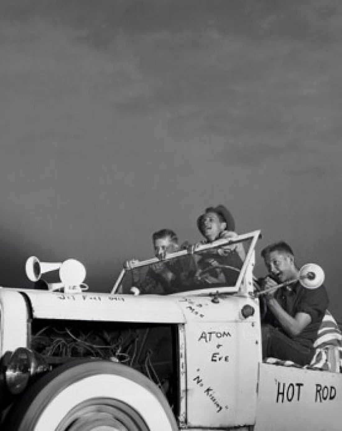 Low angle view of three teenage boys sitting in a vintage car Canvas Art - (18 x 24)