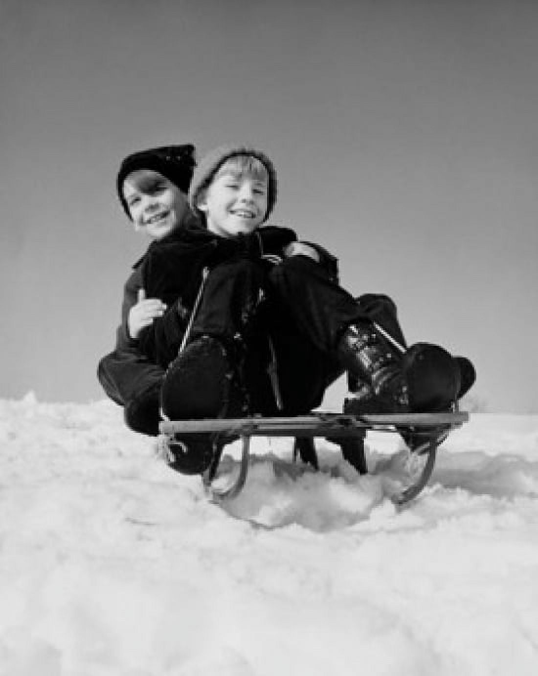 Low angle view of two boys riding a sled Canvas Art -  (18 x 24)