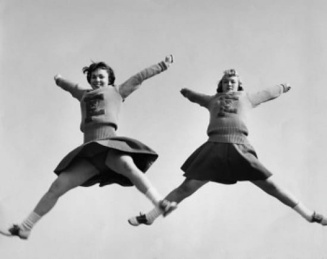 Low angle view of two female cheerleaders cheering Canvas Art - (18 x 24)