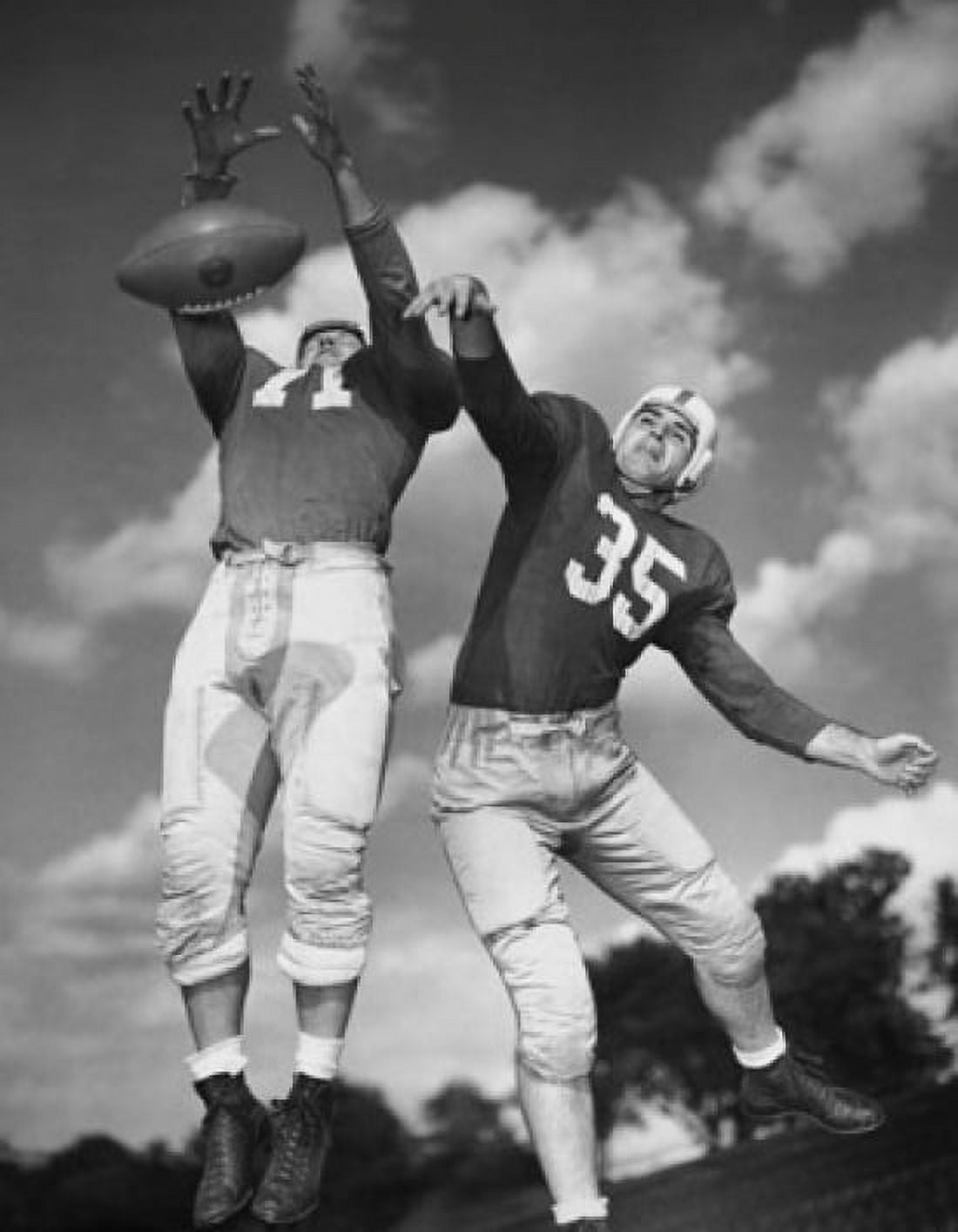 Low angle view of two football players playing football Canvas Art - (24 x 36)