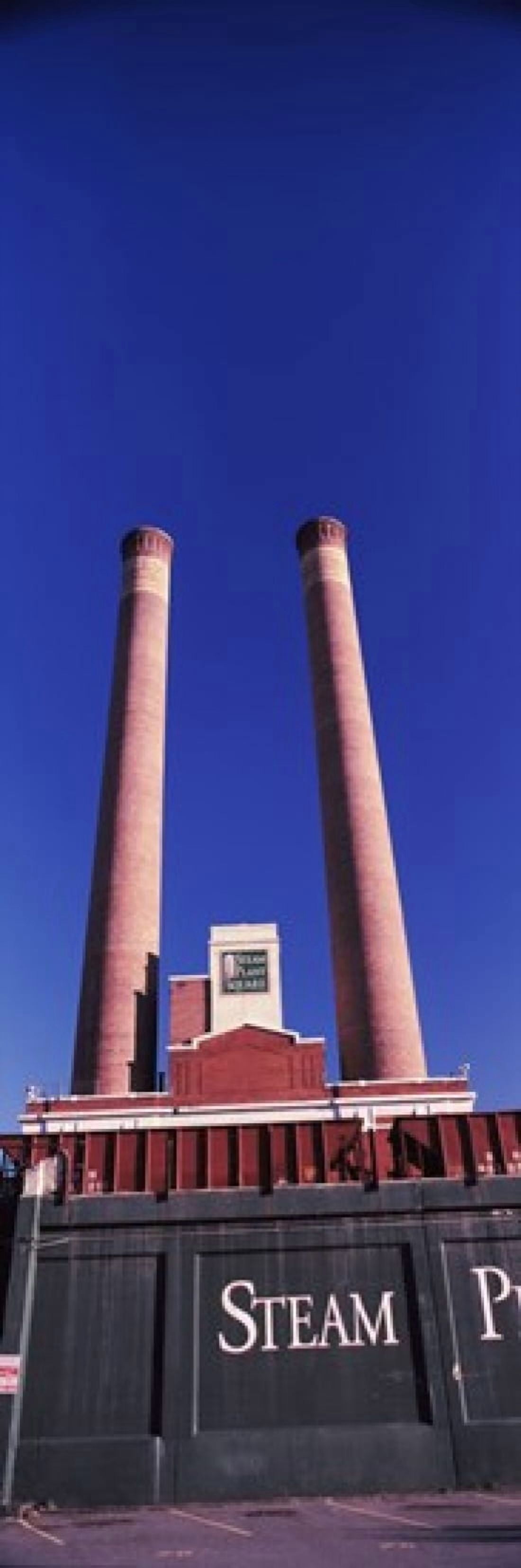 Low angle view of two smoke stacks at Steam Plant Square Spokane Washington State USA Canvas Art - Panoramic Images (36 x 12)