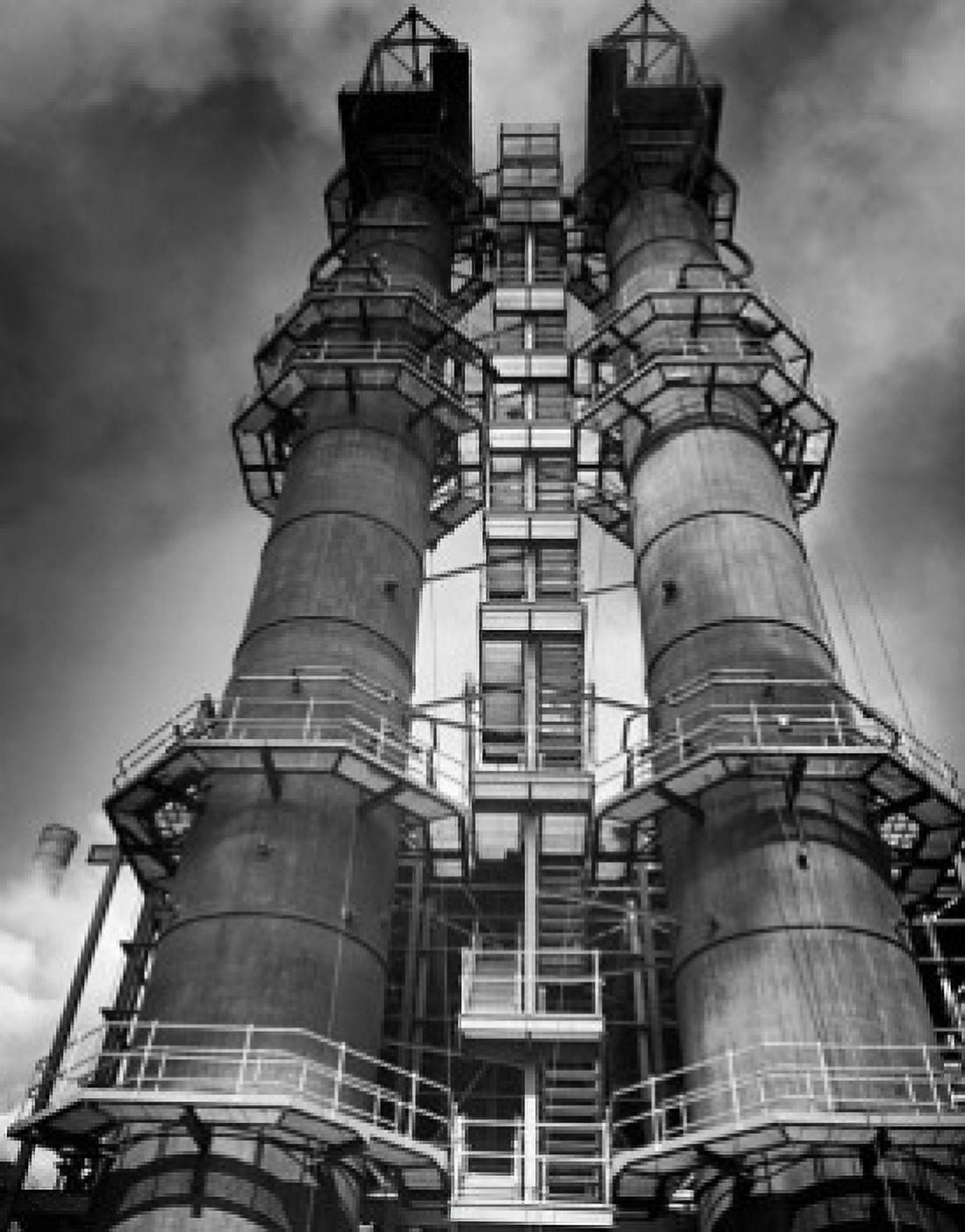 Low angle view of two smoke stacks of a factory Canvas Art - (24 x 36)
