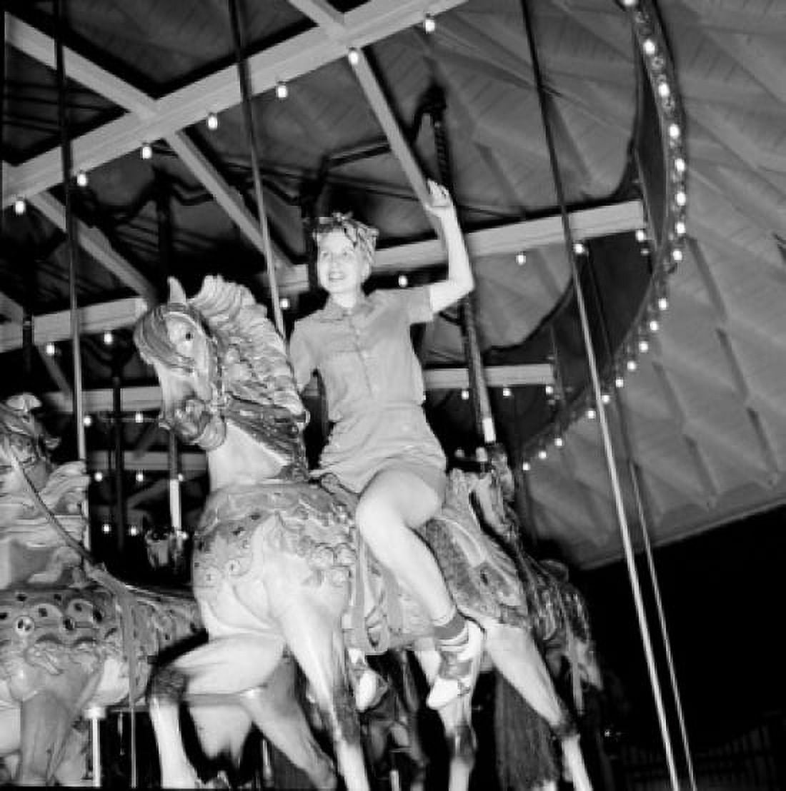 Low angle view of woman riding carousel Canvas Art - (18 x 24)