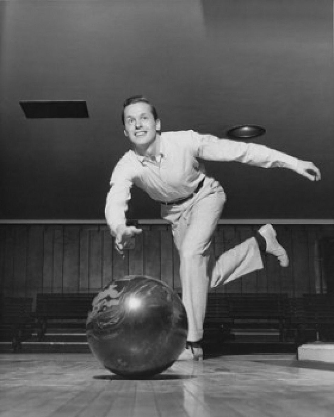 Low angle view of young adult man bowling Canvas Art - (24 x 36)