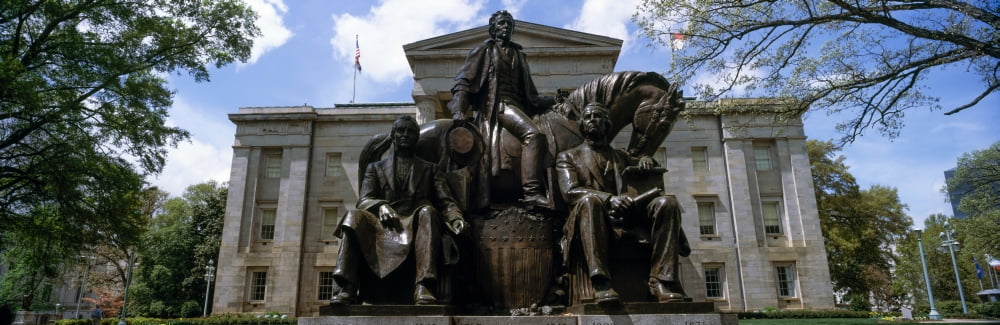 Low angle view of statue with a government building in the background North Carolina State Capitol Raleigh North Carolina USA Canvas Art - Panoramic Images (36 x 12)