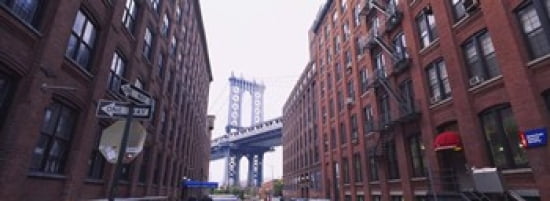 Low angle view of a suspension bridge viewed through buildings Manhattan Bridge Brooklyn New York City New York State USA Canvas Art - Panoramic Images (36 x 13)