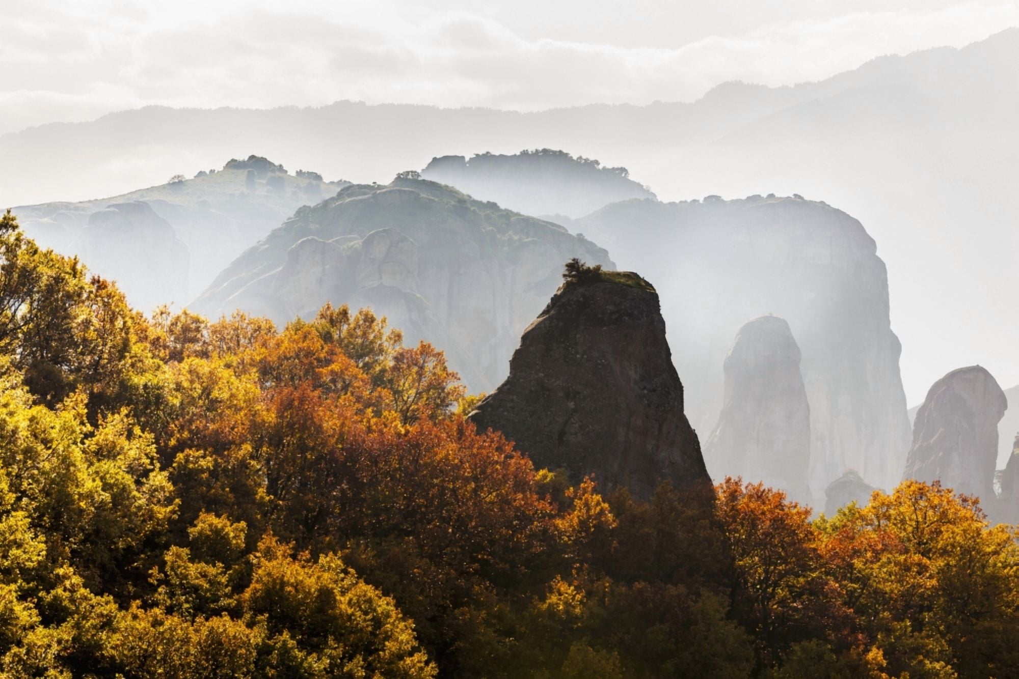 Low cloud around the rugged cliffs with foliage in autumn colours Meteora Greece Canvas Art - Reynold Mainse Design Pics (19 x 12)