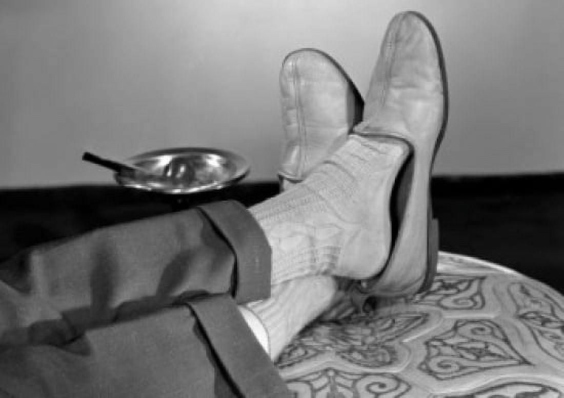 Low section of man relaxing with legs crossed at ankles Canvas Art - (18 x 24)