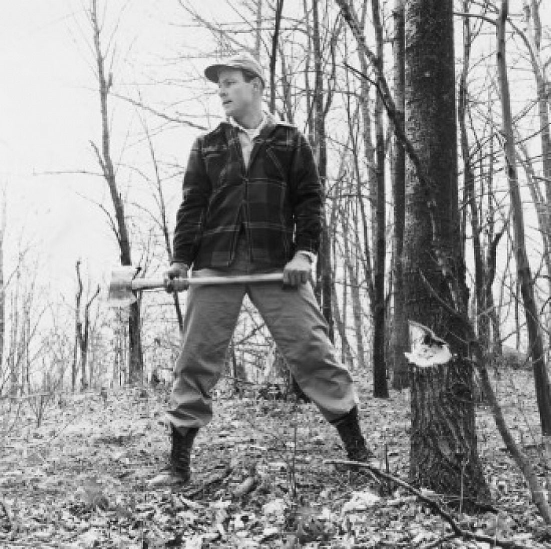 Lumberjack holding an axe and standing in a forest Canvas Art - (18 x 24)