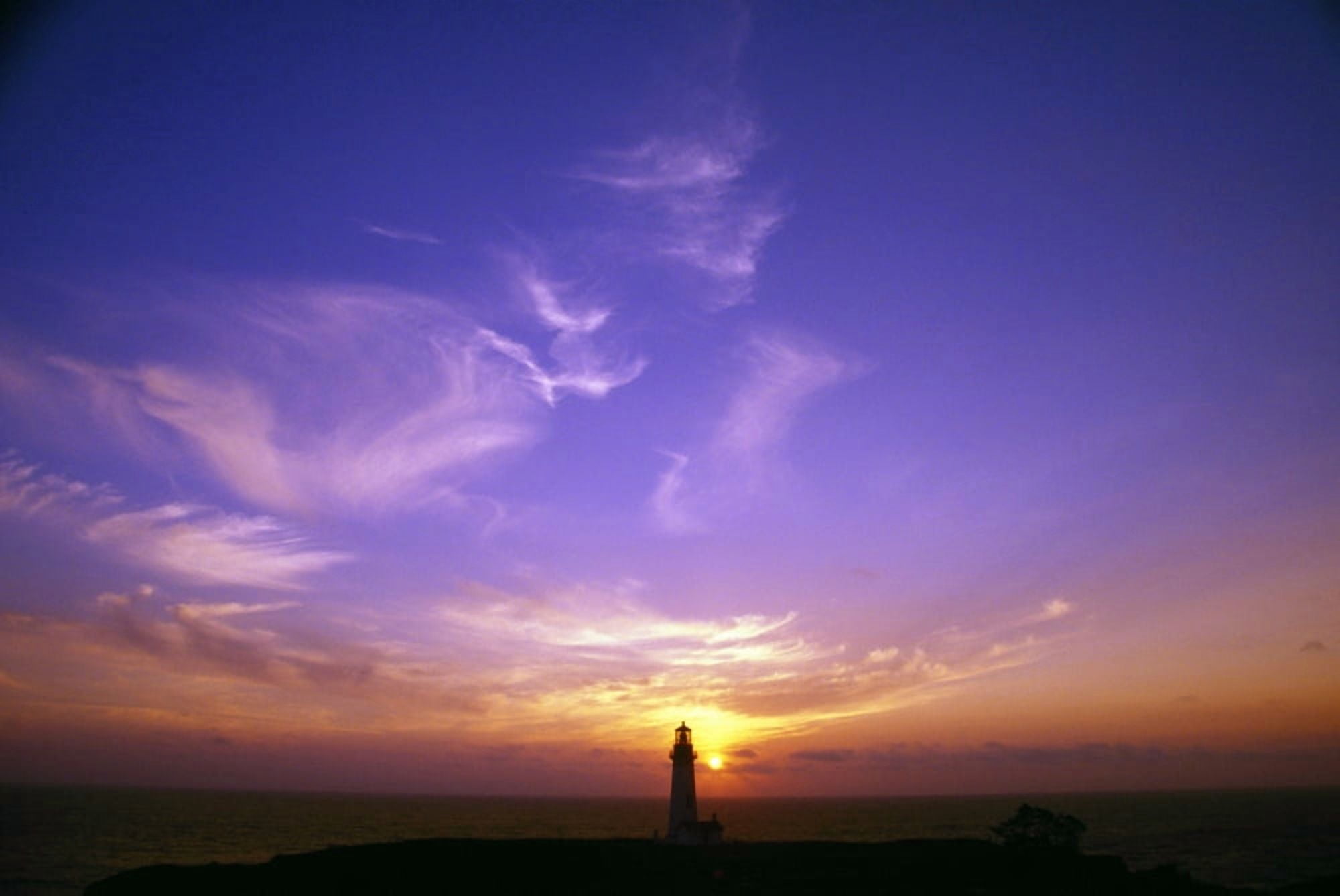 Luminous Sky Behind Distant Lighthouse Canvas Art - Natural Selection Craig Tuttle Design Pics (36 x 24)