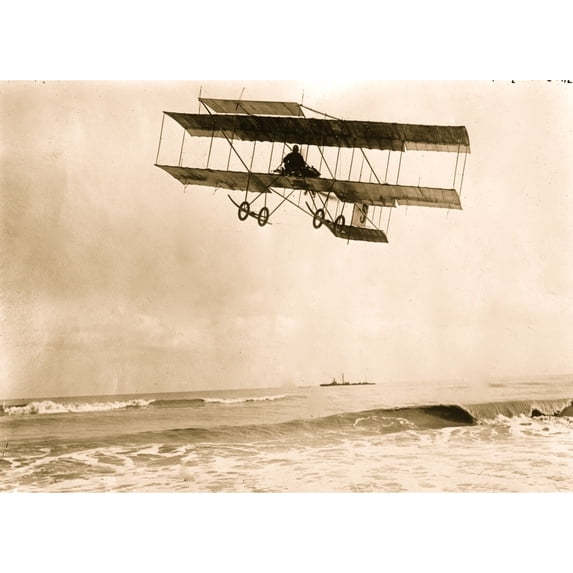 M. Van den Born flying above the sea. A ship is on the horizon Poster Print (18 x 24)