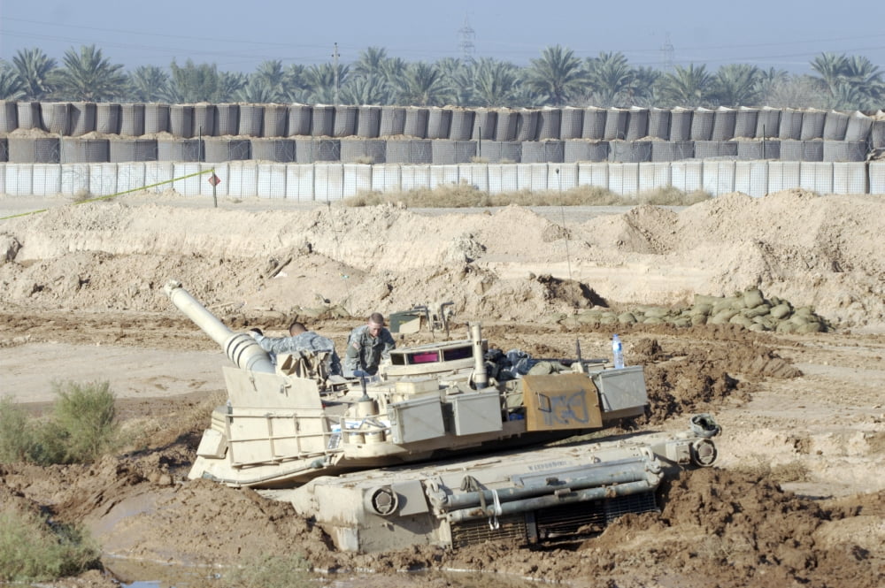 M1 Abrams tank is bogged when trying to cross wet area at the end of Camp Warhorses small runway Canvas Art - Terry MooreStocktrek Images (35 x 23)