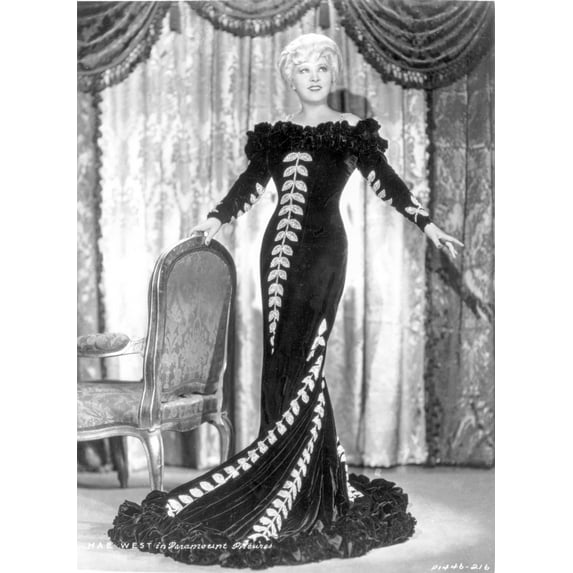 Mae West standing in Black Long Gown with Arm's Open Photo Print (24 x 30)