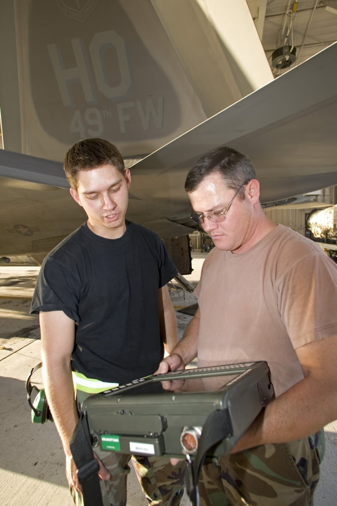 Maintenance crew works on an F-22 Raptor Canvas Art - HIGH-G ProductionsStocktrek Images (12 x 18)
