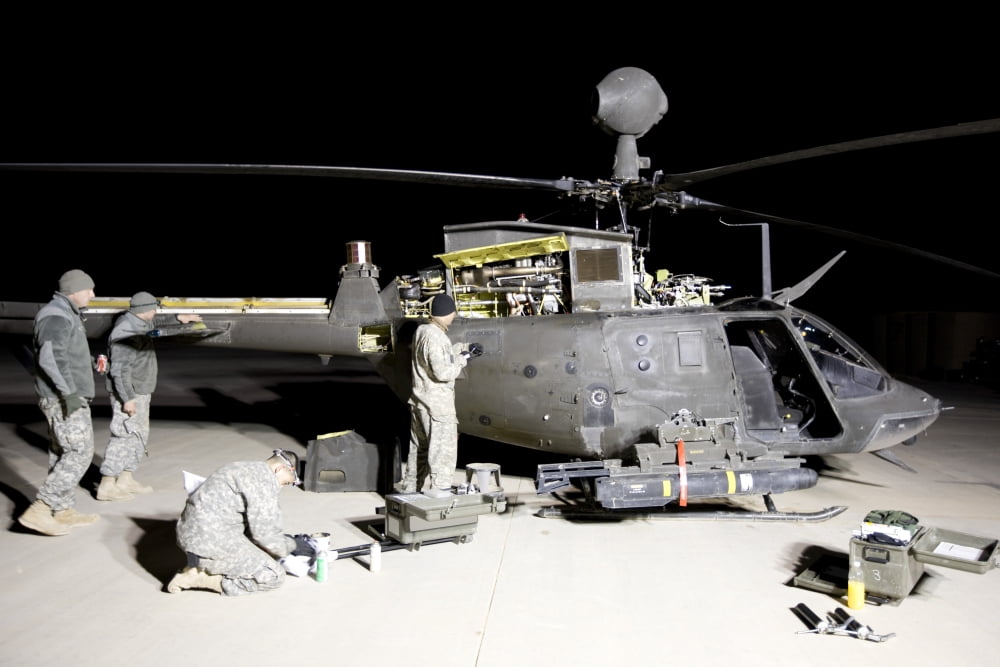 Maintenance crew works on servicing the OH-58 Kiowa before its next mission Canvas Art - Terry MooreStocktrek Images (18 x 12)