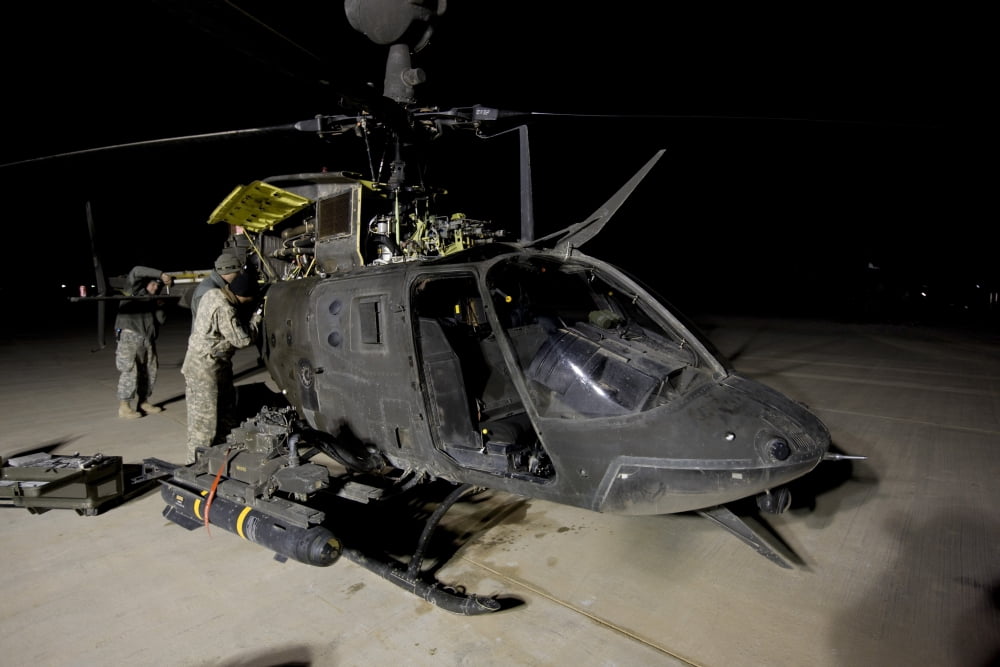 Maintenance crew works on servicing the OH-58 Kiowa before its next mission Canvas Art - Terry MooreStocktrek Images (35 x 23)