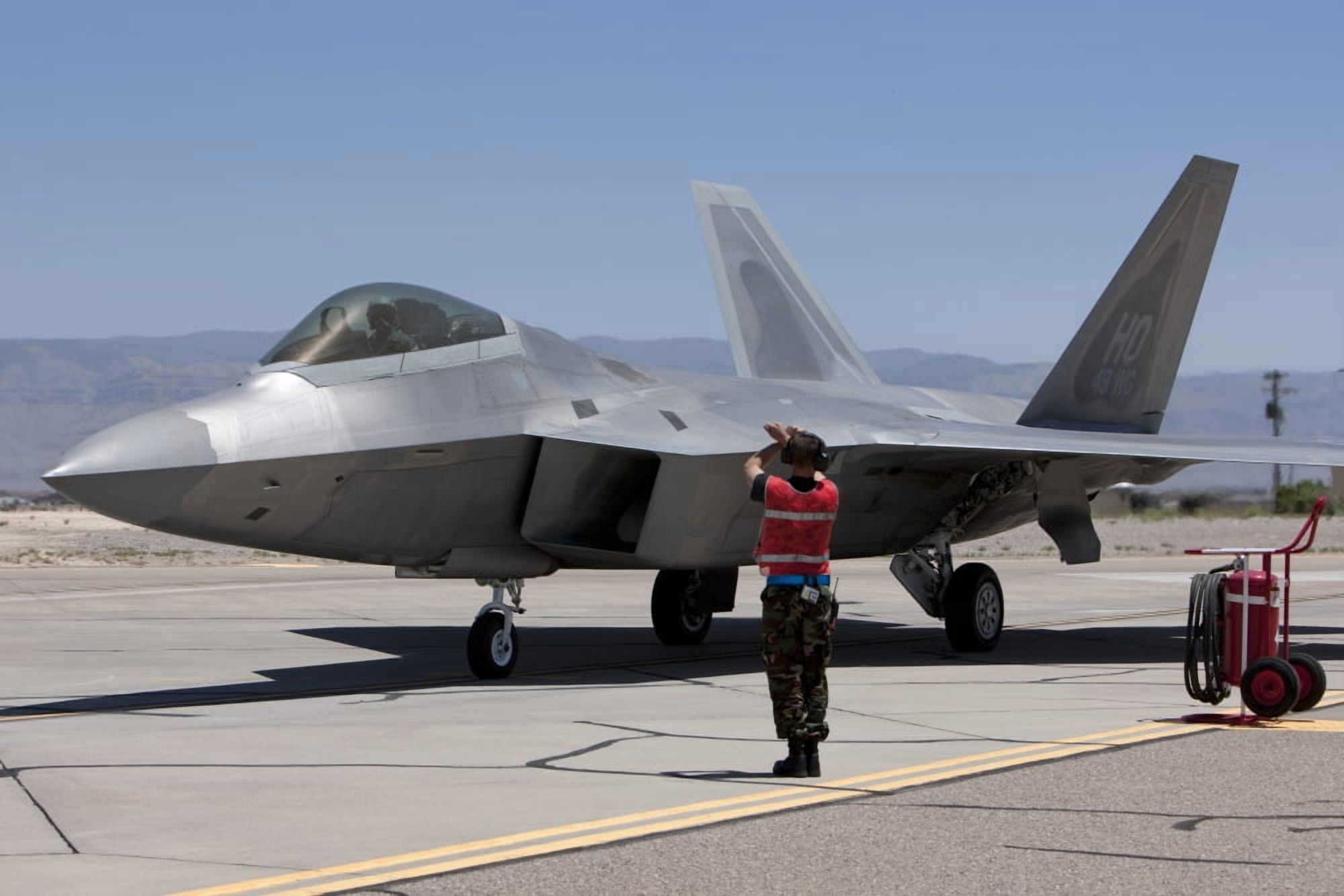 Maintenance crews perform preflight checks with F-22 Raptors Canvas Art - HIGH-G ProductionsStocktrek Images (35 x 23)