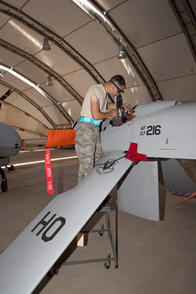 Maintence crews work on an MQ-1 Predators engine Canvas Art - HIGH-G ProductionsStocktrek Images (12 x 18)