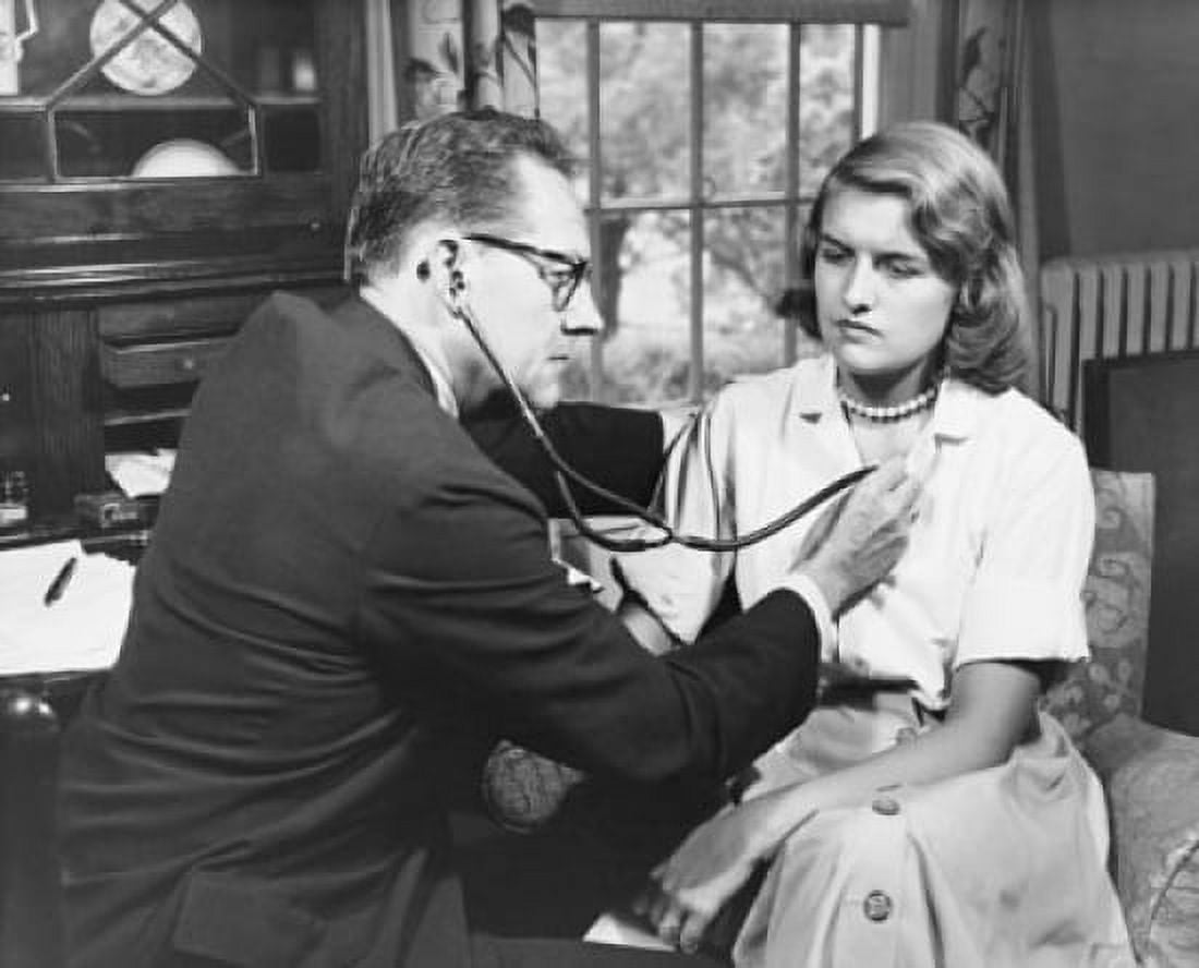 Male doctor examining a female patient with a stethoscope Canvas Art - (24 x 36)
