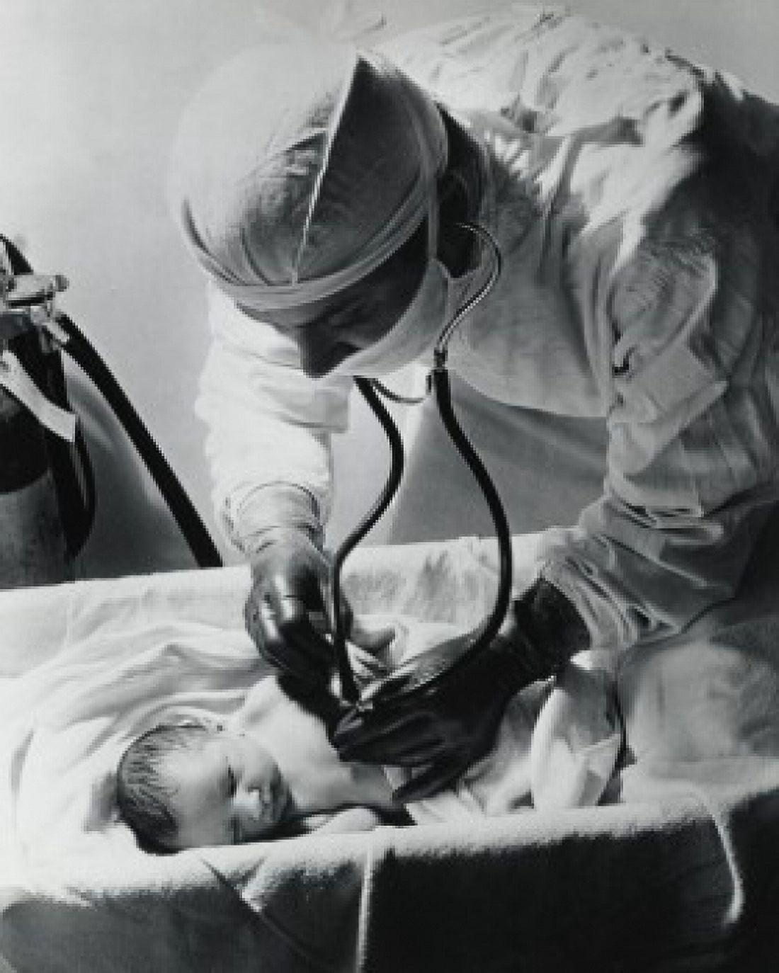 Male doctor examining a newborn baby Canvas Art - (18 x 24)