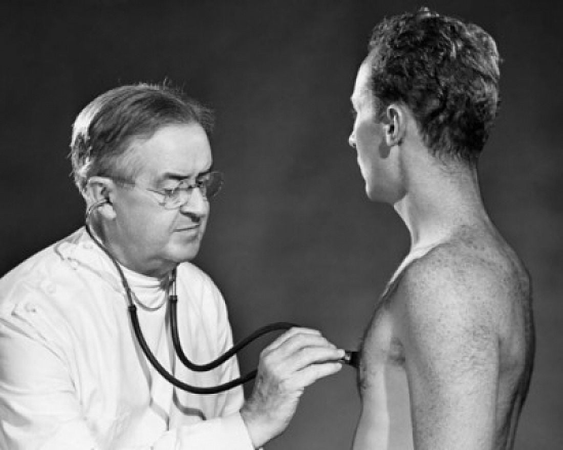 Male doctor examining a patient Canvas Art - (18 x 24)