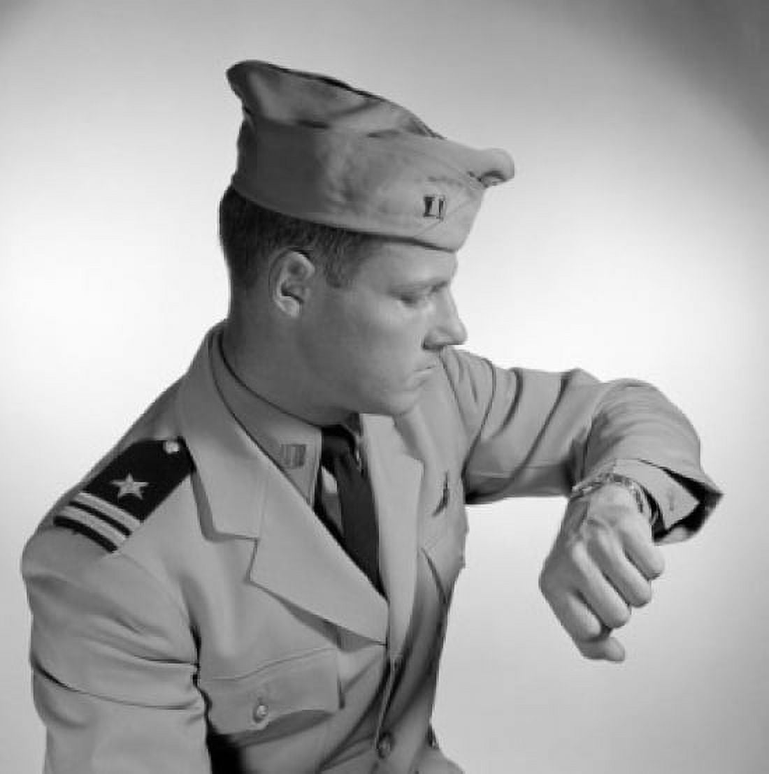 Male navy soldier checking time on wristwatch Canvas Art - (24 x 36)