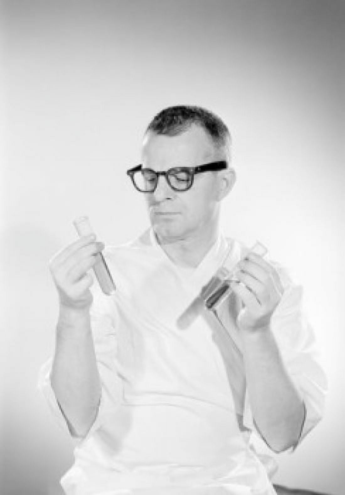 Male scientist examining test tubes with liquid Canvas Art - (18 x 24)