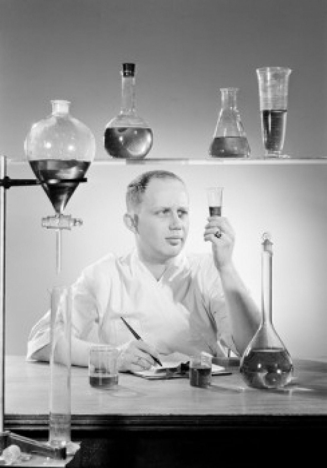 Male scientist examining test tubes with liquid Canvas Art - (24 x 36)