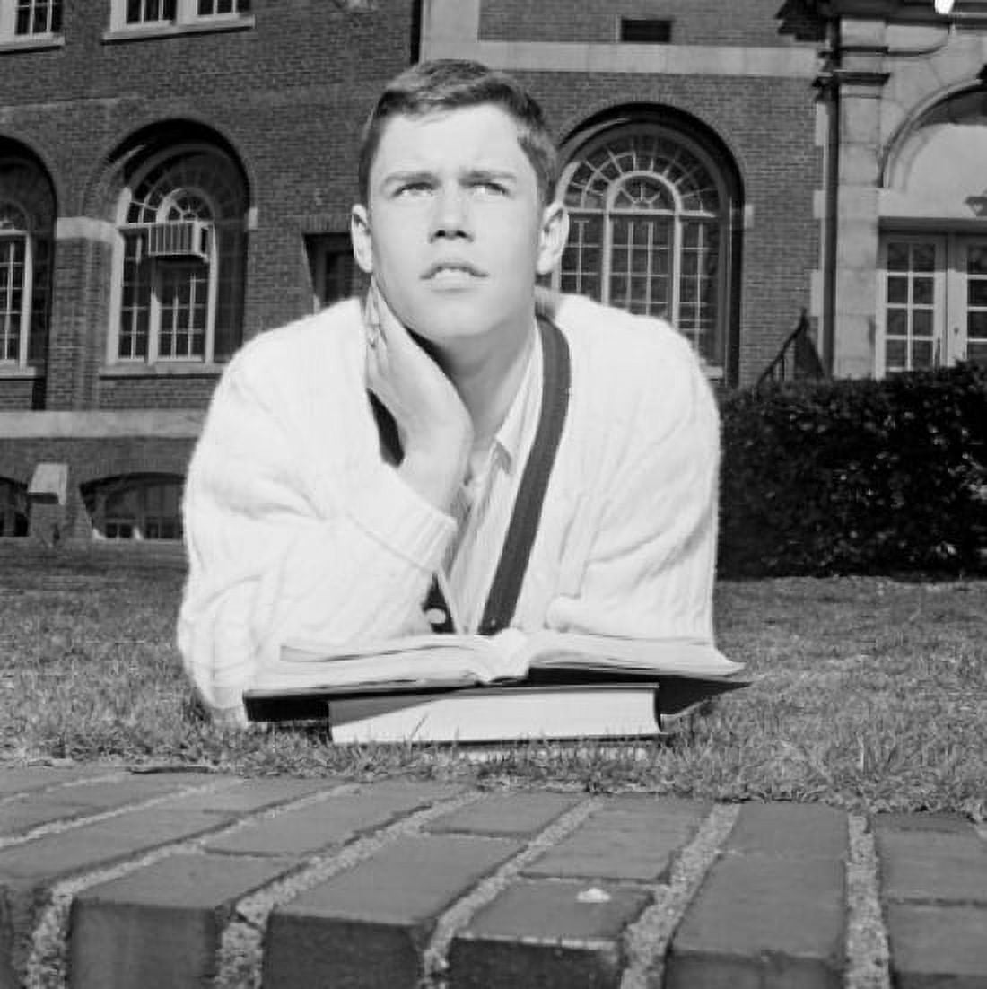 Male student lying on grass outside university Canvas Art - (18 x 24)