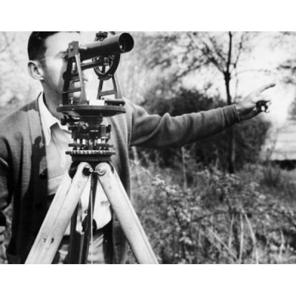 Male surveyor looking through a theodolite Canvas Art - (24 x 36)