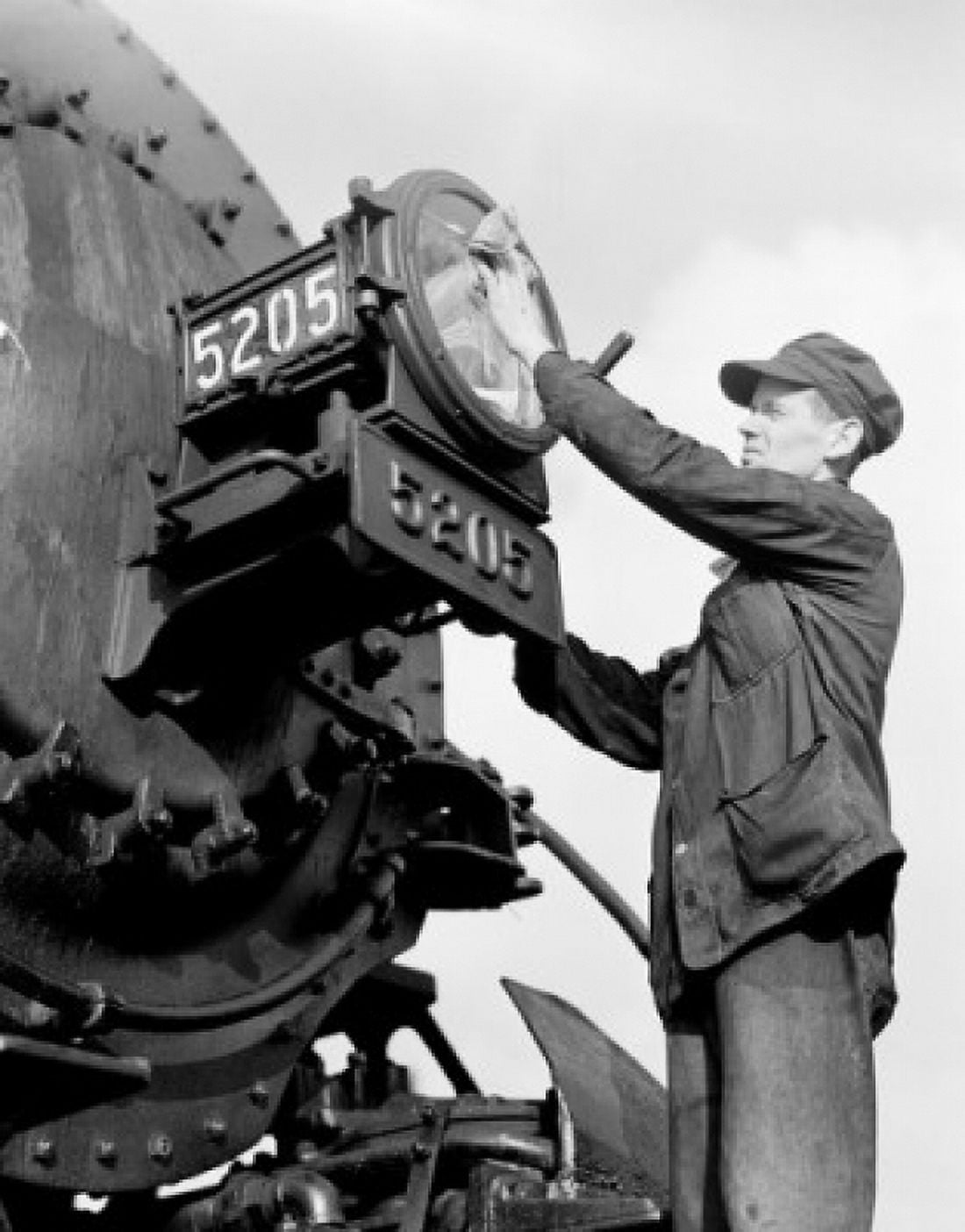 Male worker cleaning train headlight Canvas Art - (24 x 36)