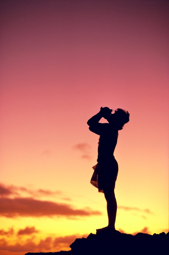 Man Silhouetted At Sunset Conch Shell Blower Canvas Art - Robert Sablan Design Pics (24 x 38)