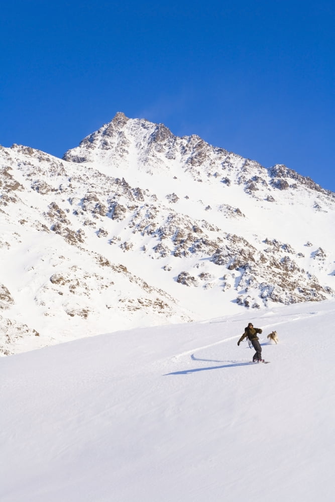 Man Snowboarding Down A Mountain Near Eagle River Winter In Southcentral Alaska Canvas Art - Michael DeYoung Design Pics (22 x 34)