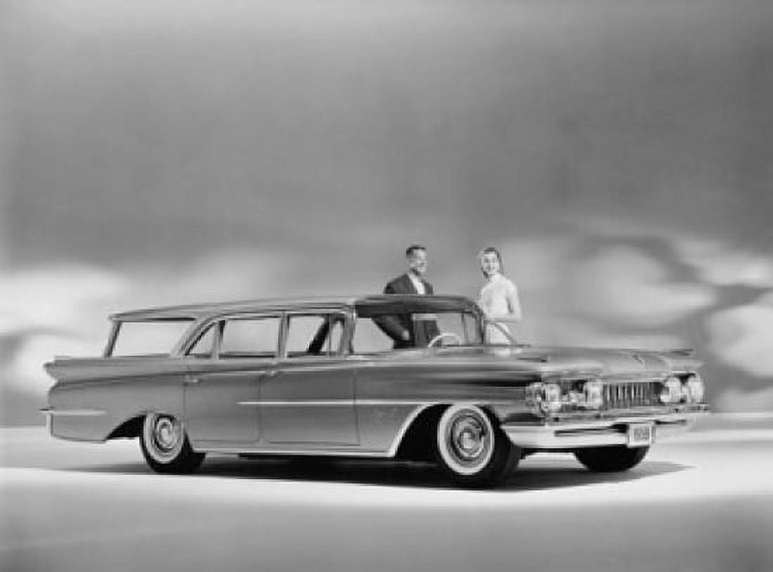 Man and a woman standing near a 1959 Oldsmobile Super 88 Fiesta Canvas Art - (24 x 36)