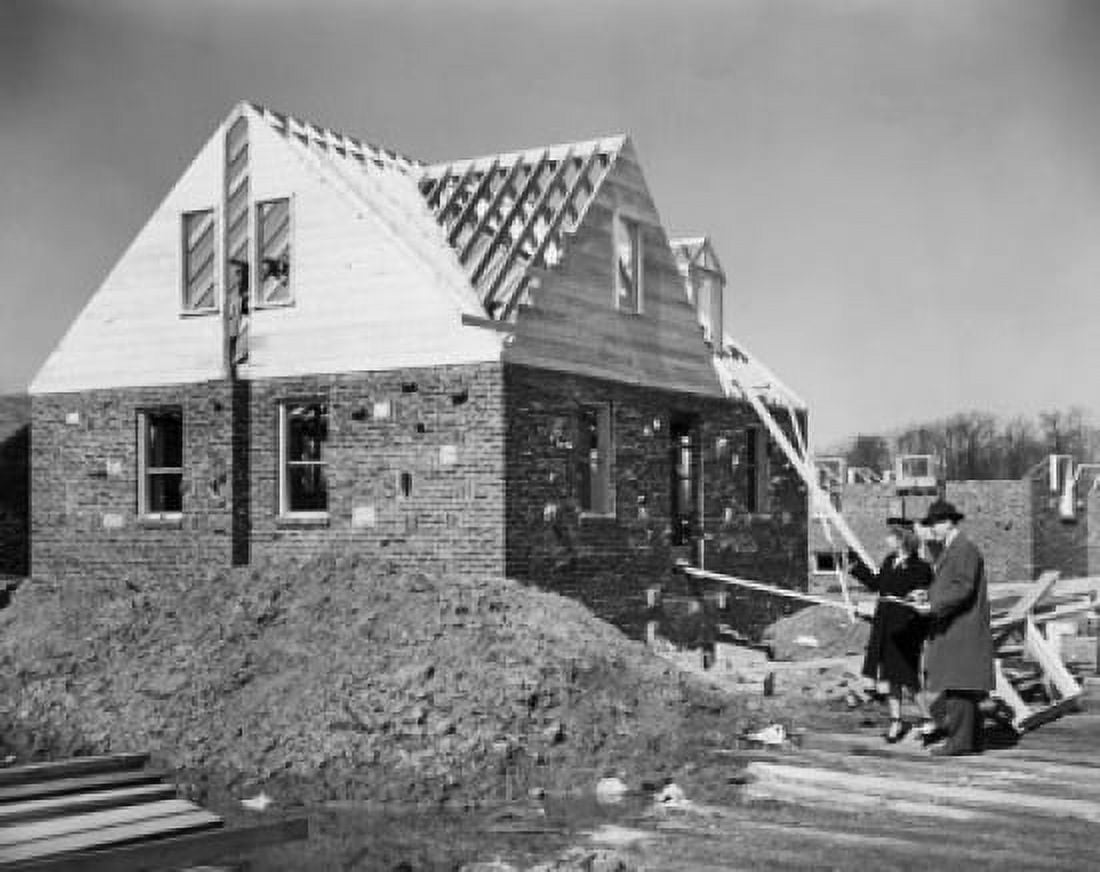 Man and woman looking at a house under construction Canvas Art - (18 x 24)