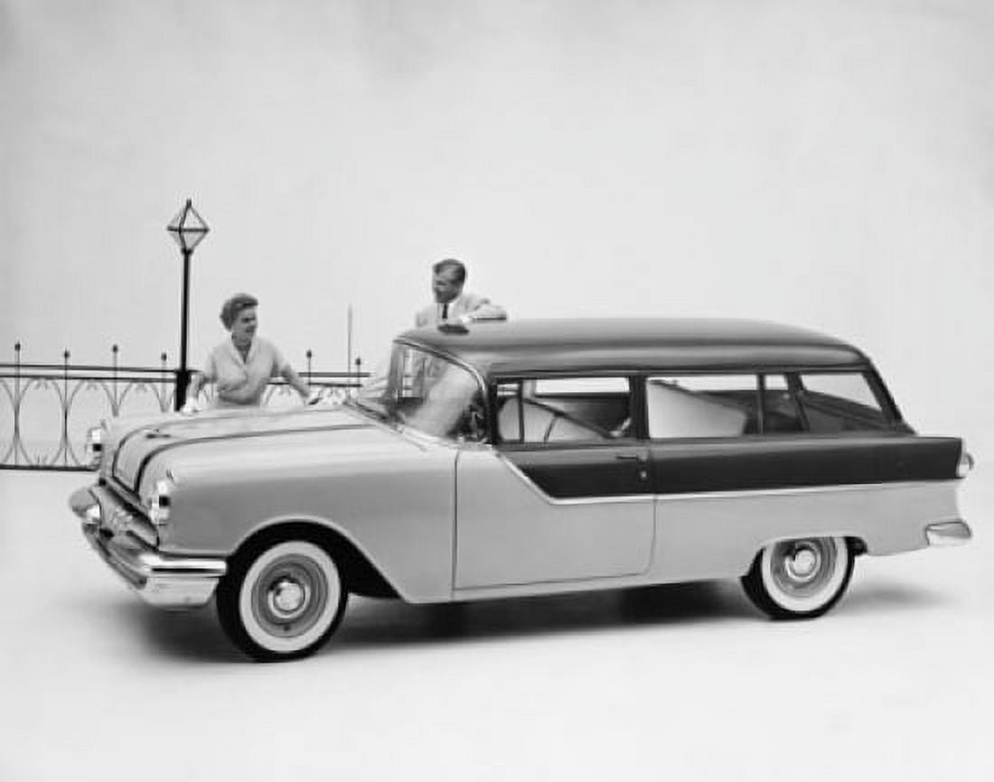 Man and woman standing near Pontiac Chieftain 860 Station Wagon Canvas Art - (18 x 24)