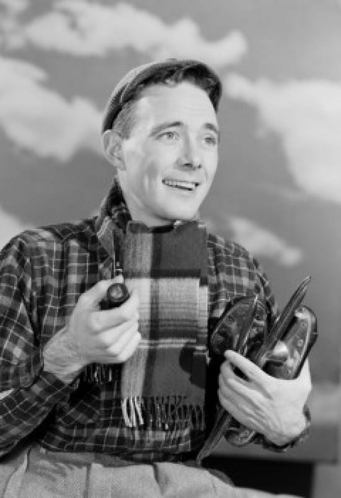 Man carrying ice skates and smoking pipe Canvas Art - (24 x 36)