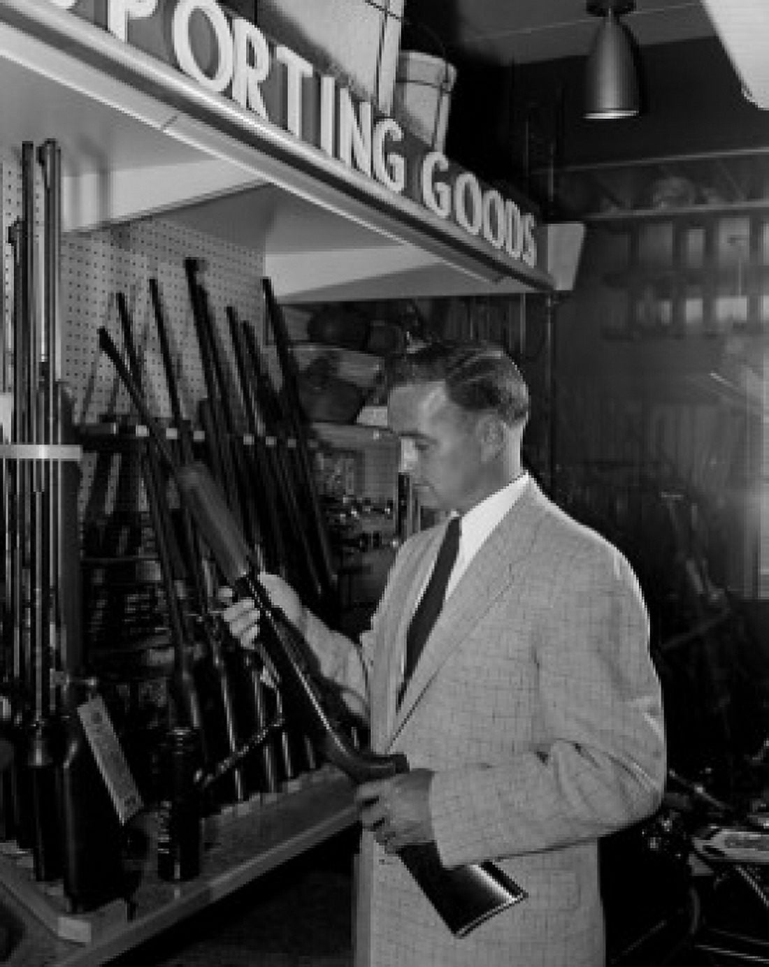Man choosing airgun in shop Canvas Art - (18 x 24)
