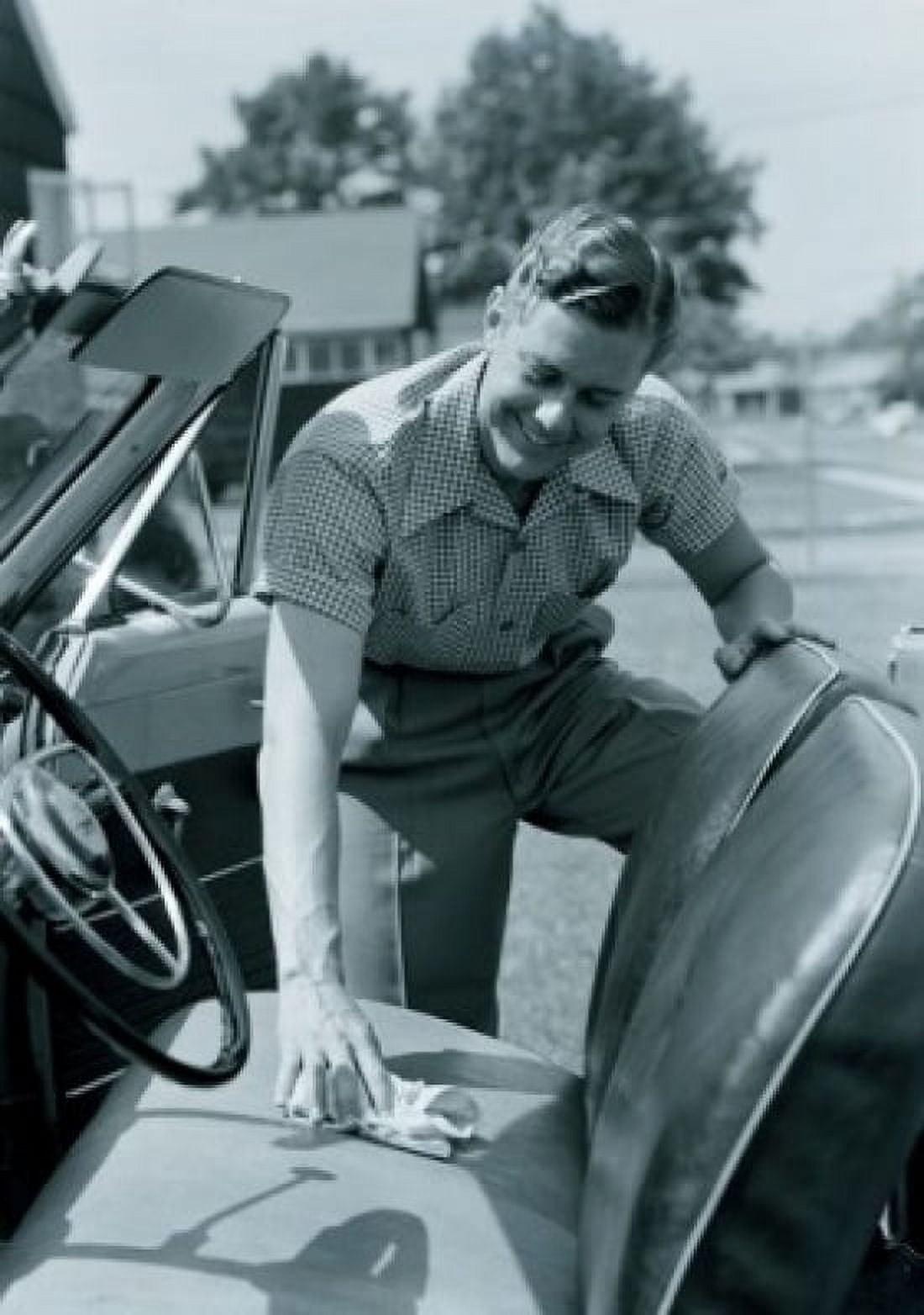 Man cleaning seat of convertible car Canvas Art - (18 x 24)