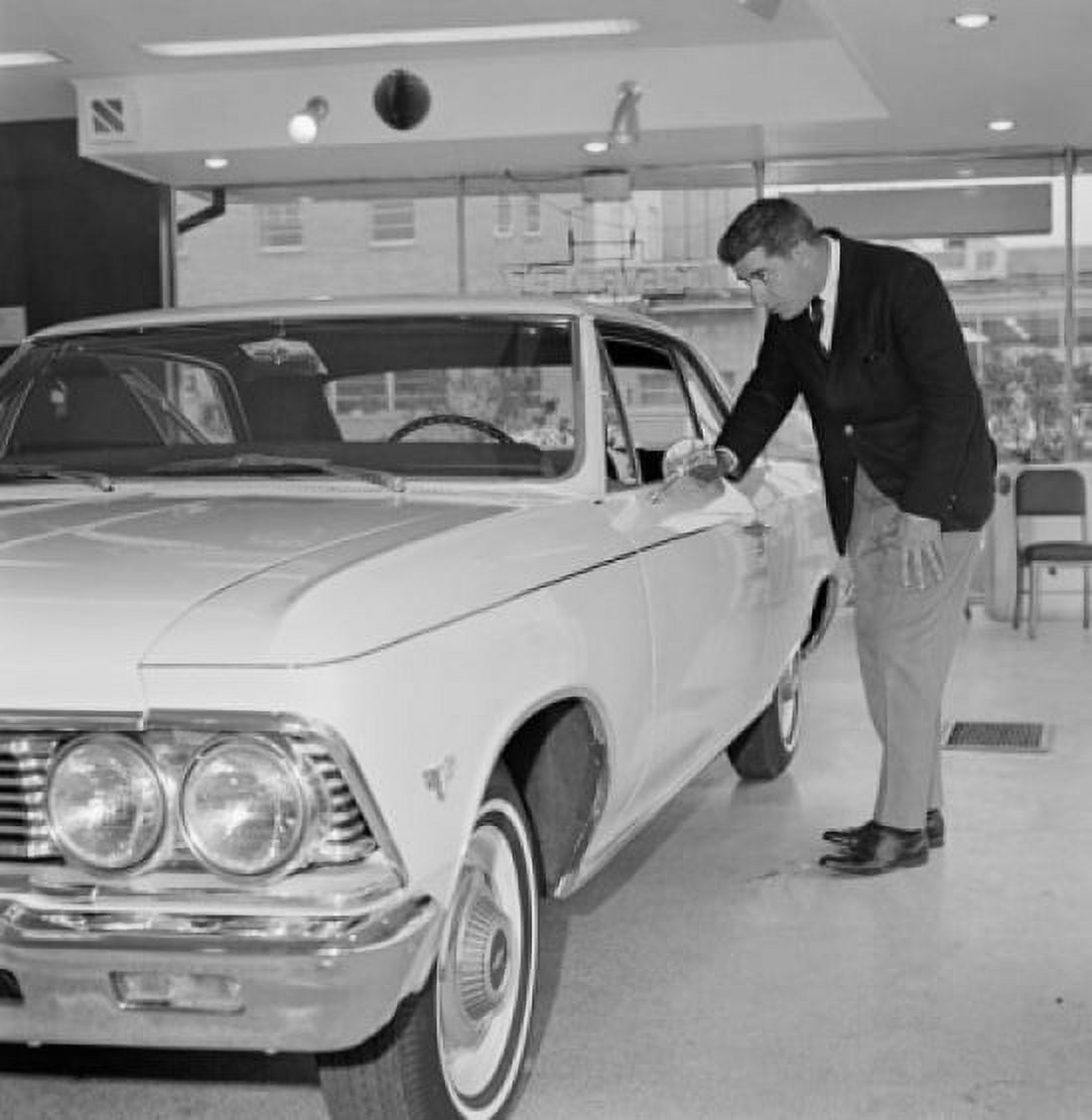 Man examining new car in salesroom Canvas Art - (18 x 24)