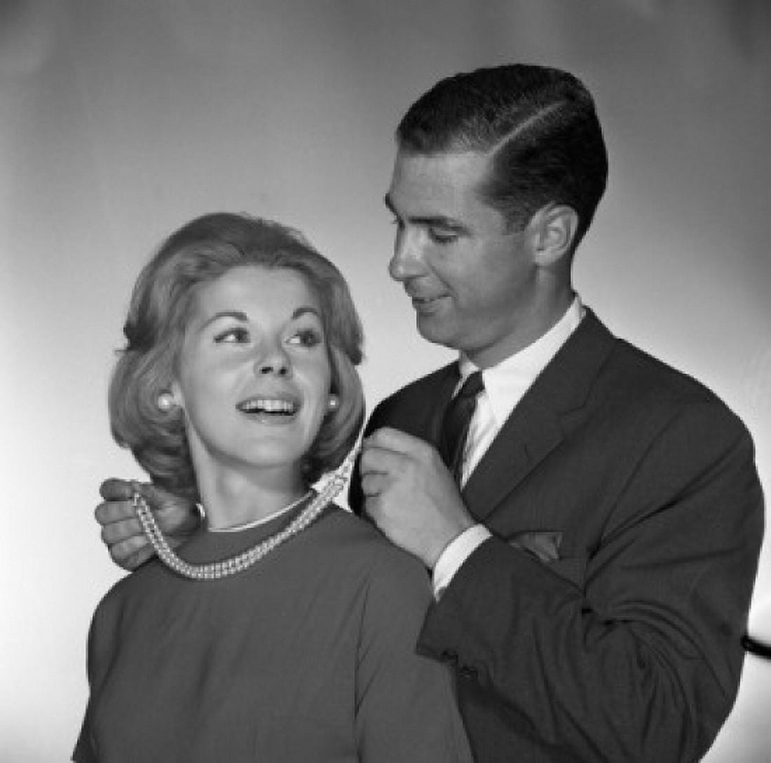 Man fastening to woman pearl necklace studio shot Canvas Art - (24 x 36)