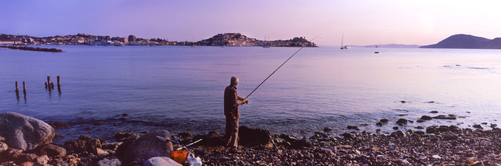 Man fishing at the coast Portoferraio Island of Elba Tuscany Italy Canvas Art - Panoramic Images (27 x 9)
