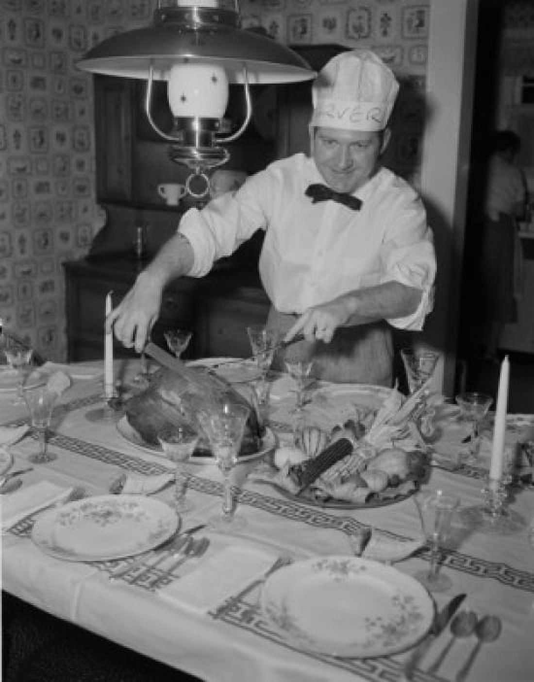 Man in chiefs hat cutting roasted turkey Canvas Art - (24 x 36)
