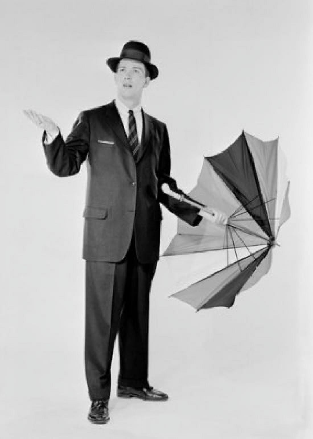 Man in suit holding umbrella and checking for rain Canvas Art - (18 x 24)
