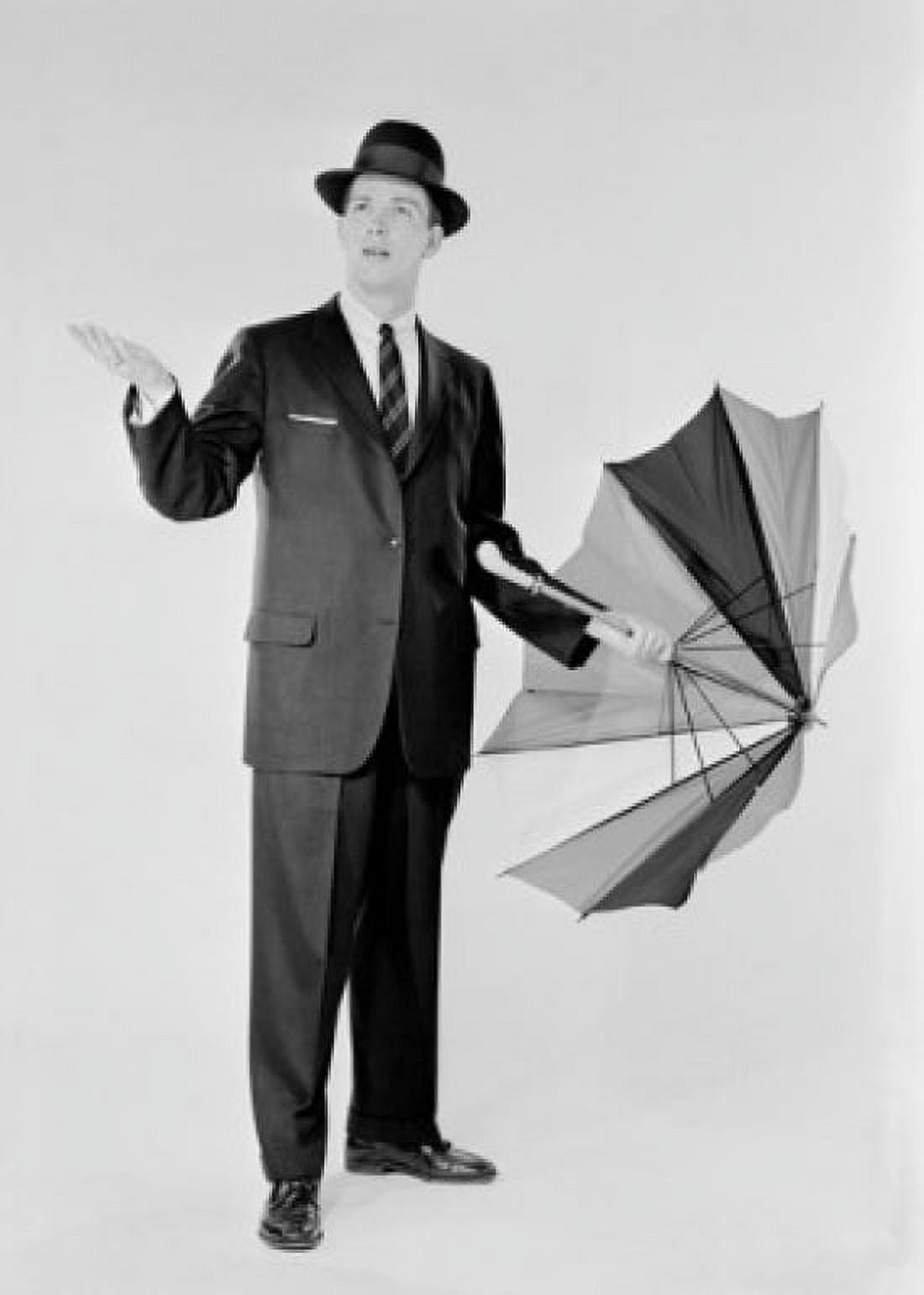 Man in suit holding umbrella and checking for rain Canvas Art - (24 x 36)