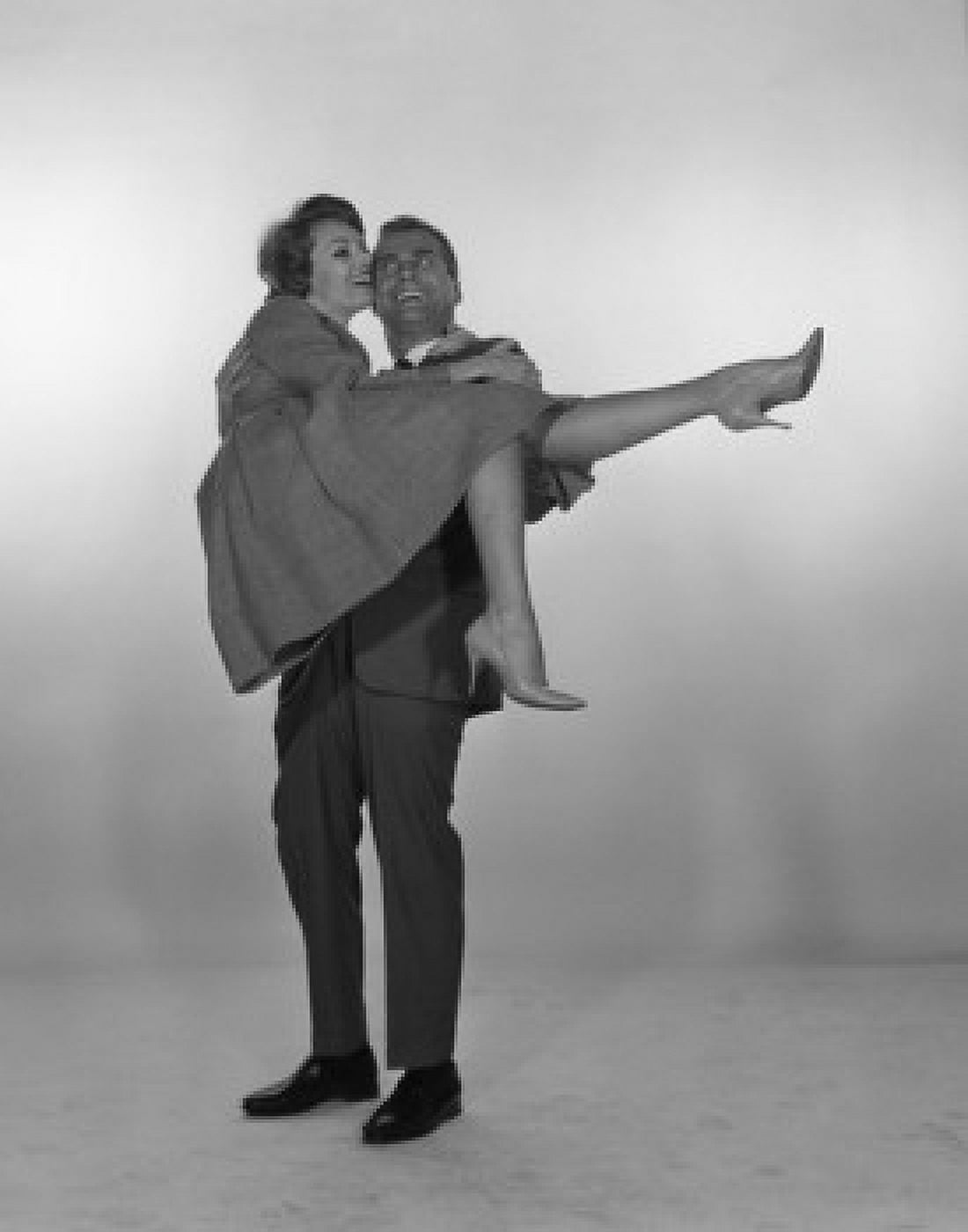 Man laughing and carrying woman studio shot Canvas Art - (24 x 36)