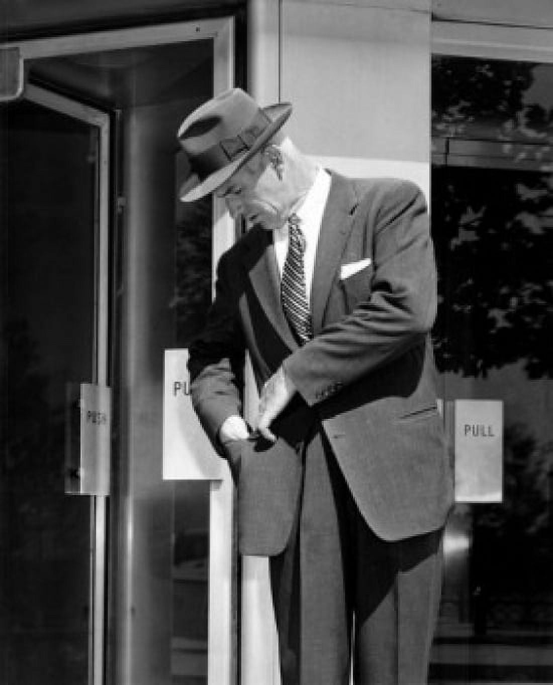 Man looking into pocket outside store Canvas Art - (18 x 24)