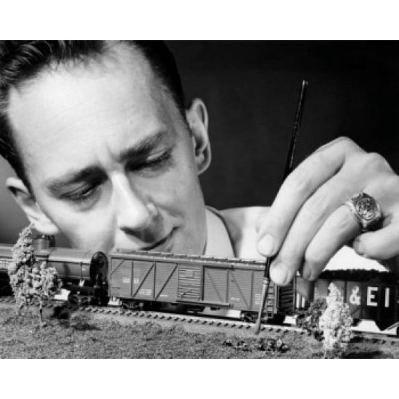 Man making scaled down model of railroad Canvas Art - (18 x 24)